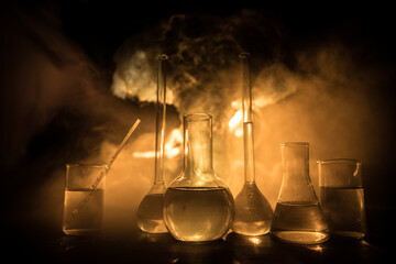 Test glass flask with solution in research laboratory. Science and medical background. Laboratory test tubes on dark toned background , science research equipment concept