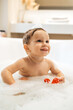 © zinkevych - Male child having a foam bath with toys