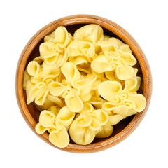 Wall Mural - Boiled fagottini, Italian pasta, in a wooden bowl. Typically shaped dumplings, made by cutting pasta dough into squares, placing the filling in the center, and folding the corners, to meet in a point.