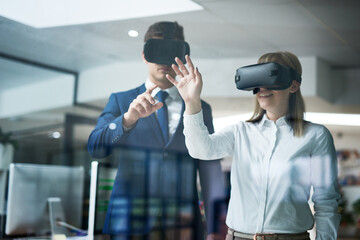 Poster - This is what the future of business looks like. Multiple exposure shot of two coworkers brainstorming together in the office while wearing VR headsets.