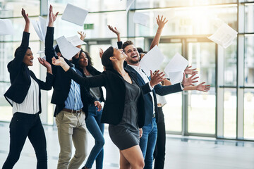 Poster - Fun and laughter in the office. Shot of a group of cheerful businesspeople lifting their hands in joy while being funny inside of the office at work.