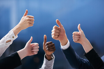 Sticker - Teamwork trumps all. Shot of a group of office workers giving thumbs up together.