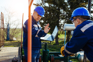 Wall Mural - Two engineers working inside oil and gas refinery