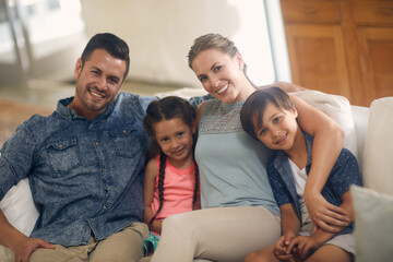 Wall Mural - Nothing is more important that family. Shot of a family of four spending quality time together at home.