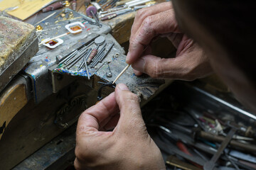 Hands of an artisan jeweler working jewelry. Jewelry Goldsmith