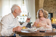 © Westend61 - Senior couple having breakfast at table in boutique hotel