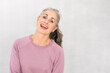 © Westend61 - Happy woman with gray hair against white background
