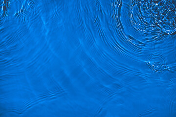 transparent dark blue clear water surface texture with ripples, splashes and bubbles. abstract natur