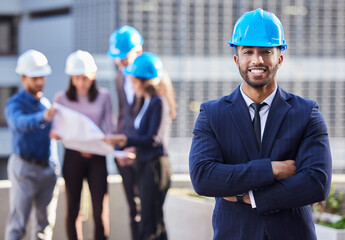 Sticker - Ive got the team that can make it happen. Shot of a young businessman standing with his arms folded and wearing a hardhat while his colleagues stand behind him.