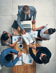 Poster - Success is on the top of their agenda. High angle shot of a group of businesspeople having a meeting in an office.