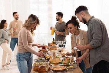 Wall Mural - Group of people enjoying brunch buffet together indoors