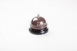 © Designerant - Service bell, ring for a coffee brown service bell on isolated white background, profil or side view photo. Service concept idea photo with copy space.