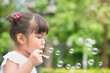 © 9nong - Cute little girl playing, blowing bubble in outdoor summer city park