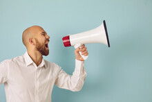 Young Man Isolated On Green Studio Background Scream In Loudspeaker Make Sale Announcement To Public. Male Hold Megaphone Shout Advertise Inform Big Sale Deal Or Promotion Discount. Advertisement.