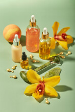 Cosmetic Care Products In Glass Bottles With Orchid Flowers - Serums, Cream, Gel, Oils. Concept For Face And Body Care, Wellness And Spa, Tropical Relaxation.