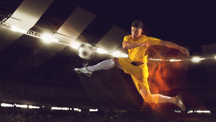 Wall Mural - Bright dynamic collage with professional soccer, football player kick the ball in jump at dark night stadium with flashlights. Sport, competition, championship