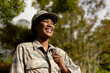 © WavebreakMediaMicro - Happy female mid adult african american soldier with backpack outside house