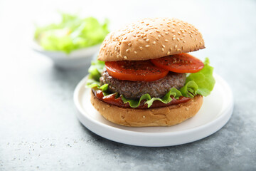 Wall Mural - Traditional homemade burger with fresh tomato