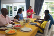 © wavebreak3 - African american having lunch together at dining table on thanksgiving day