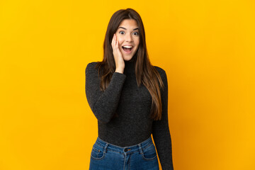 Teenager Brazilian girl isolated on yellow background with surprise and shocked facial expression