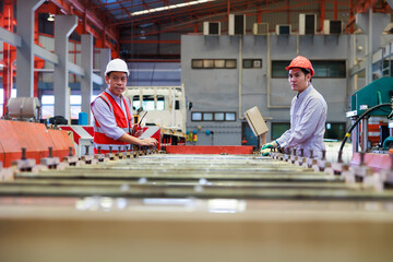 Poster - Factory engineer worker operating metal sheet roof machine at Heavy Industry Manufacturing Factory. worker in safety hardhat at factory industrial facilities