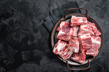 Wall Mural - Raw diced beef and lamb marbled meat in kitchen steel tray. Black background. Top view. Copy space