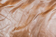 Background from natural crumpled leather. Beige, brownish color