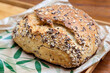 Fresh bread from the bakery with a crispy crust, sprinkled with various seeds
