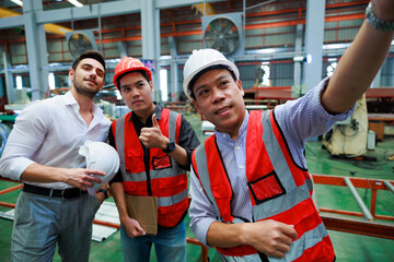 Wall Mural - Selfie by smartphone. Caucasian business man and Factory engineer talking and discussion at Heavy Industry Manufacturing Factory. worker in safety hardhat at factory industrial facilities