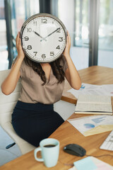 Aufkleber - Shes got time on her mnind. Shot of an unidentifiable businesswoman holding a clock in front of her face while sitting at her desk.