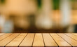 © DEEP PIXEL - Empty wooden table top with lights bokeh on blur restaurant background.