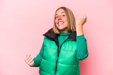 Wall Mural - Young caucasian woman isolated on pink background cheering carefree and excited. Victory concept.