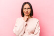 © Asier - Young hispanic woman isolated on pink background unhappy looking in camera with sarcastic expression.