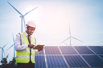 african engineer stand holding tablet front solar photovoltaic and wind turbines generating electric