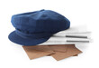 © New Africa - Blue postman's hat, envelopes and newspapers on white background