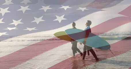 Sticker - Animation of american flag over senior african american couple walking on beach with surfboards