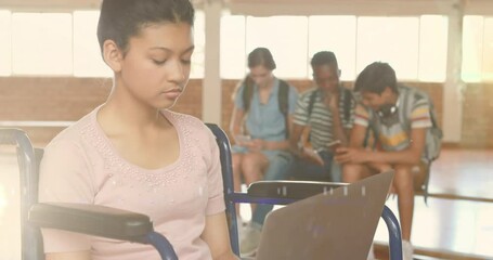 Wall Mural - Animation of lights over happy disabled biracial female student using laptop at school