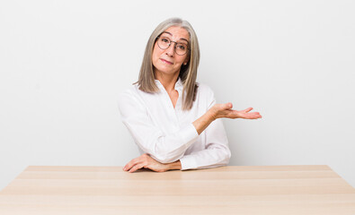 Wall Mural - senior  gray hair woman smiling cheerfully, feeling happy and showing a concept. desk and business concept