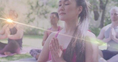 Canvas Print - Animation of light spots over diverse women practicing yoga and meditating