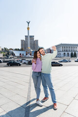 KYIV, UKRAINE - SEPTEMBER 1, 2021: Smiling couple taking selfie on Independence Square.