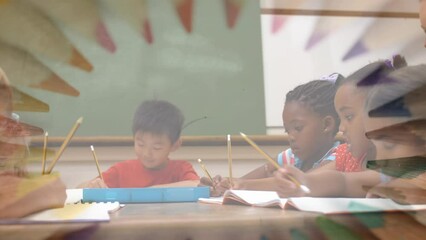 Sticker - Animation of crayons rotating over diverse pupils at school and happy caucasian female teacher