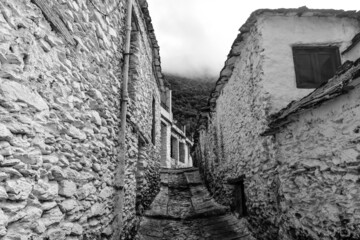 street photos in B/W in the old town of the Pampaneira white village (Pueblo blanco), Andalusia, Spain. Vernacular architecture. Stone houses. Photo 2 