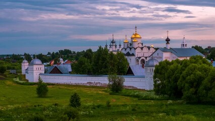 Wall Mural - Suzdal, Russia. Panoramic view of Intercession (Pokrovsky) Monastery in Suzdal, Russia during a cloudy evening. Golden tour trip in Russia. Time-lapse with fast moving clouds, zoom in