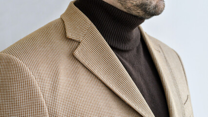 Wall Mural - Detail of men outwear, light beige blazer combined with dark brown sweater. Selective focus.