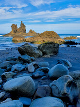 Dramatic Seascape With Sharp Rocks And Rounded Stones