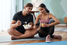 Your Diet Is Just As Important As Your Workout. Full Length Shot Of An Athletic Young Couple Enjoying Some Healthy Snacks After Their Workout At Home.