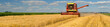 © Solid photos - Combine harvester harvesting wheat on a sunny summer day.