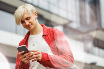 Man with phone in hands. Technology business. Freelancer doing his work on the way.