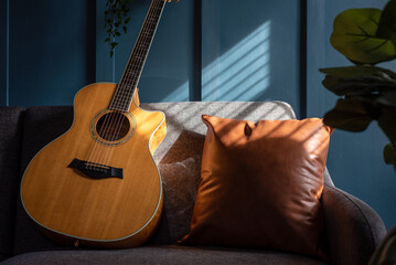 Wall Mural - Acoustic guitar on a sofa in natural light