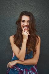 Poster - What can she be thinking about this time. Portrait of a cheerful young woman posing against a grey background outside during the day.